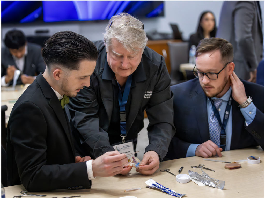 Surgeon teaching medical students how to suture